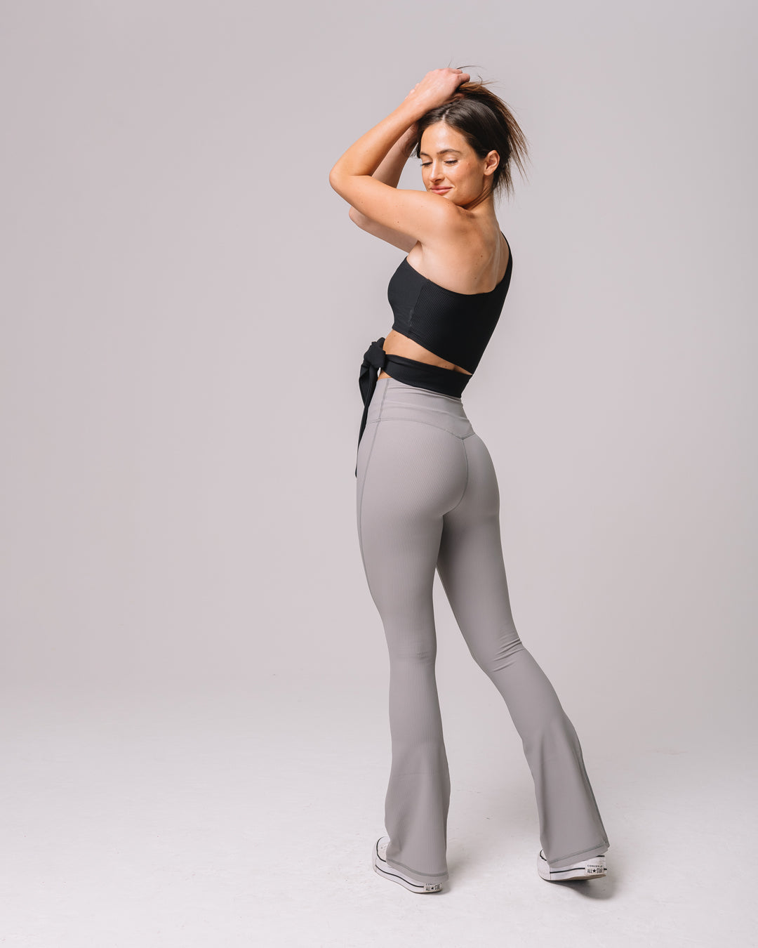 Back view of KADYLUXE® Regal Rib Flare Pant in Cement Rib