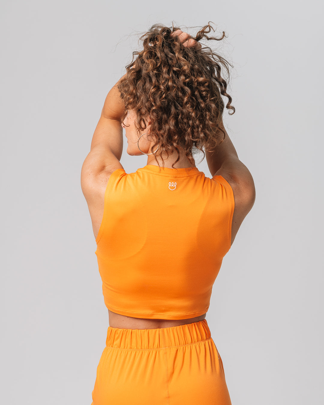 Back view of KADYLUXE® Milky Silk™ Tank in Electric Mandarin